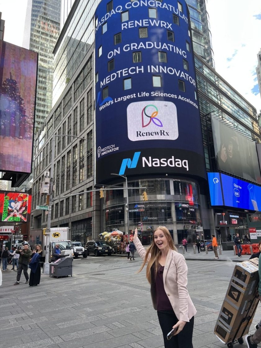 RenewRx team member celebrating the company’s MedTech Innovator graduation on the Nasdaq billboard