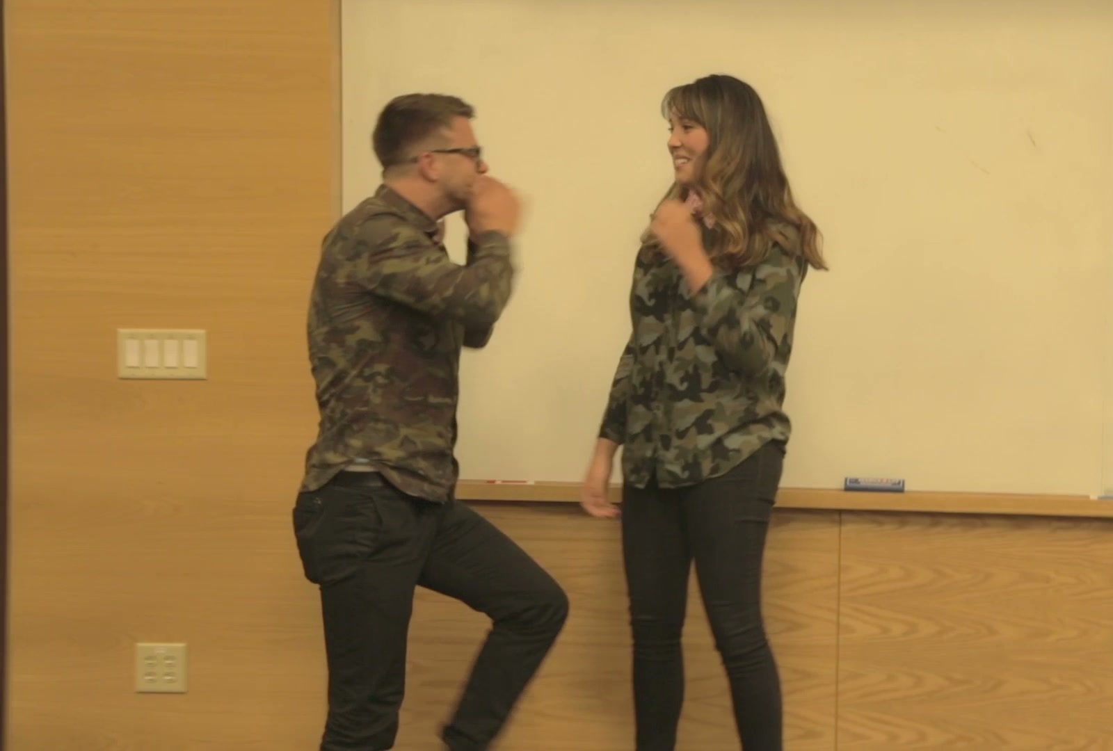 Paul Hunter and Charlee Riggio, in matching camouflage shirts, react on stage as Repurpose wins the first Innovation Challenge Finals.